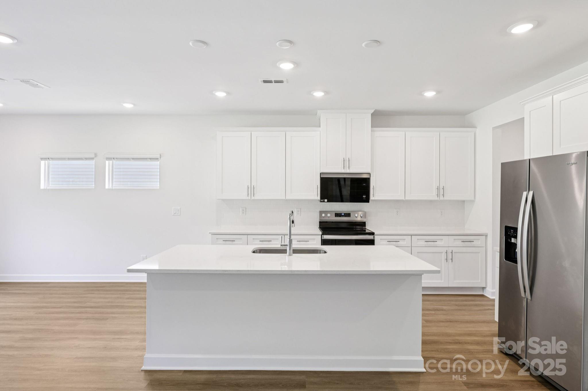 161 Murphy Mdw Road Mocksville, NC 27028 - Photo 6 of 29 a kitchen with kitchen island a sink stainless steel appliances and cabinets