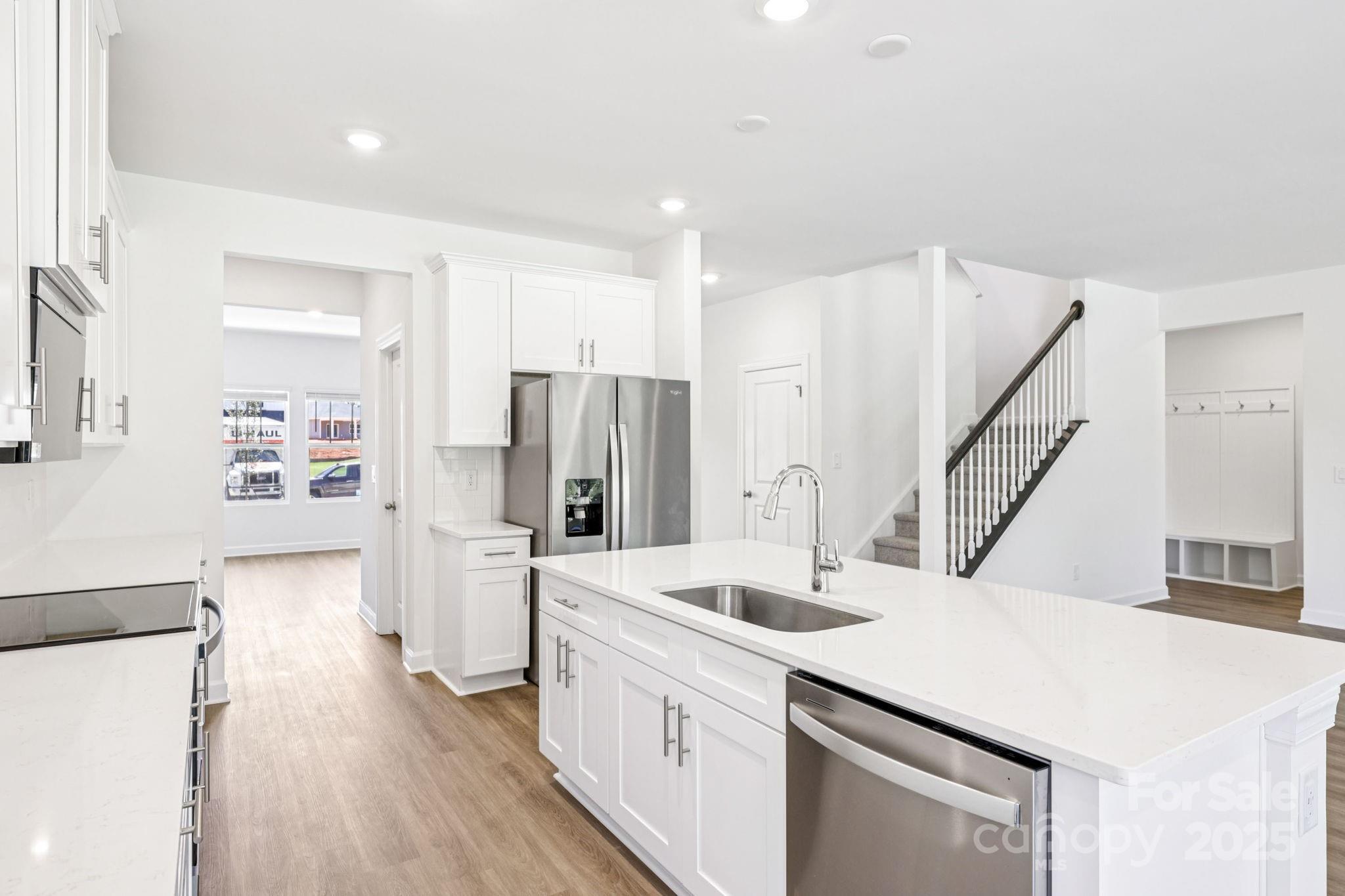 161 Murphy Mdw Road Mocksville, NC 27028 - Photo 7 of 29 a kitchen with a sink a refrigerator and a stove top oven