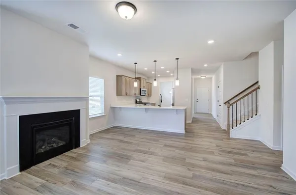 a view of kitchen and kitchen with fireplace wooden floor
