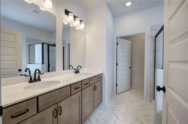 a bathroom with a double vanity sink mirror and double