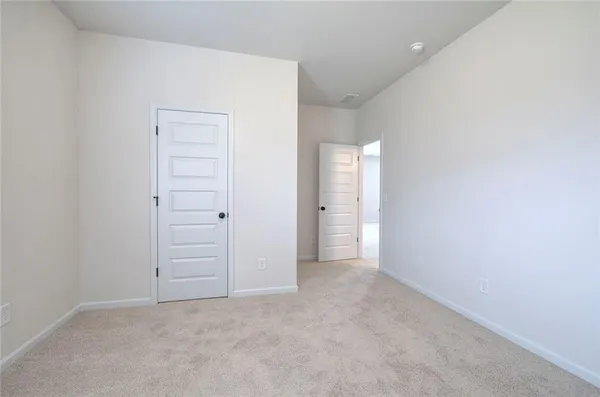 an empty room with closet area