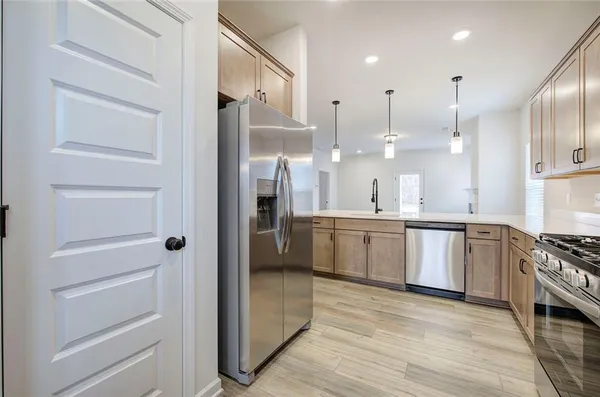 a large kitchen with a refrigerator a sink and a stove