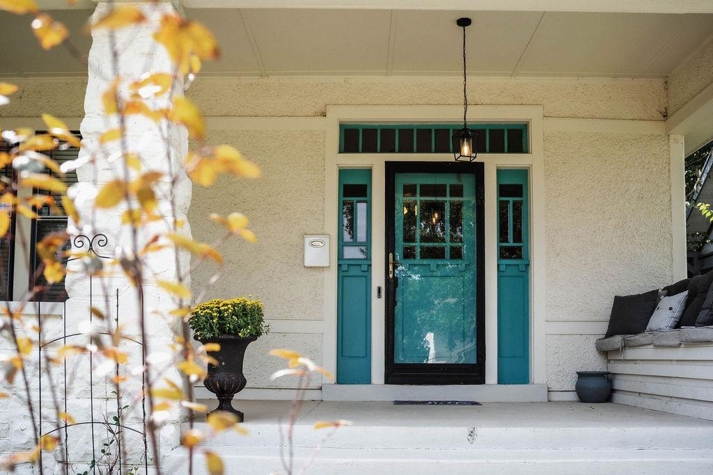 Entrance to property with stucco siding
