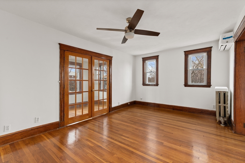 27 Union Street, Unit 3 Boston, MA 02135 - Photo 12 of 28 a view of empty room with wooden floor and fan
