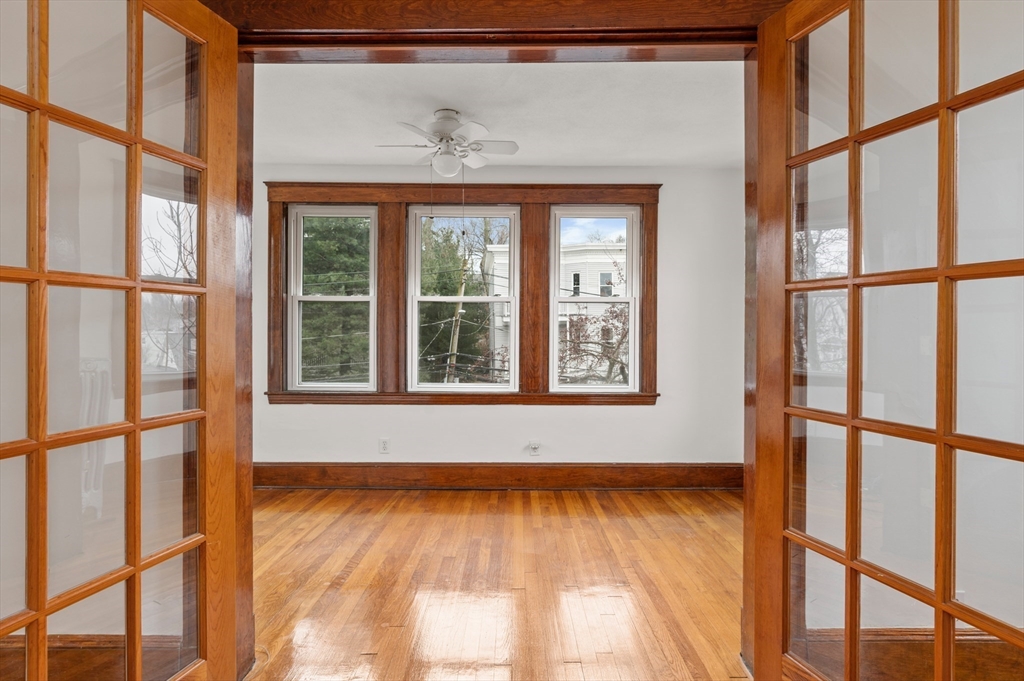 27 Union Street, Unit 3 Boston, MA 02135 - Photo 16 of 28 a view of an empty room with wooden floor and a window
