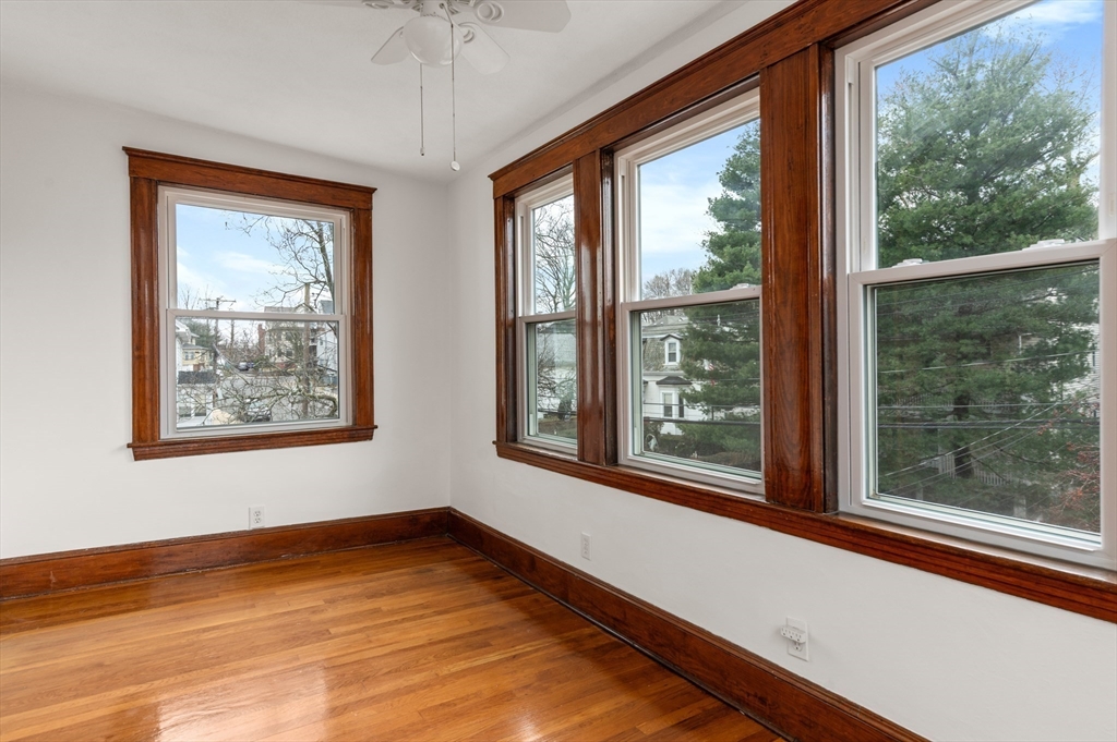 27 Union Street, Unit 3 Boston, MA 02135 - Photo 17 of 28 a view of an empty room with wooden floor and a window
