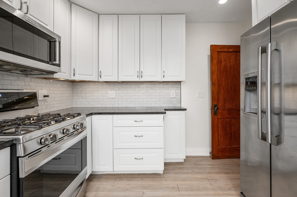 27 Union Street, Unit 3 Boston, MA 02135 - Photo 2 of 28 a kitchen with stainless steel appliances white cabinets and stove top oven
