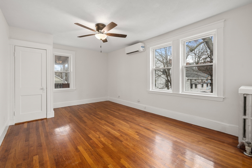 27 Union Street, Unit 3 Boston, MA 02135 - Photo 21 of 28 a view of an empty room with wooden floor and a window