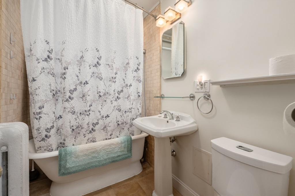 27 Union Street, Unit 3 Boston, MA 02135 - Photo 23 of 28 a bathroom with a sink a toilet and shower
