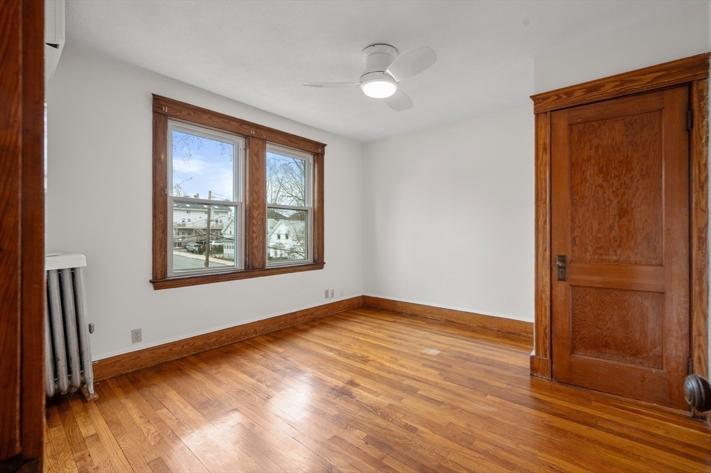 27 Union Street, Unit 3 Boston, MA 02135 - Photo 24 of 28 an empty room with wooden floor and windows