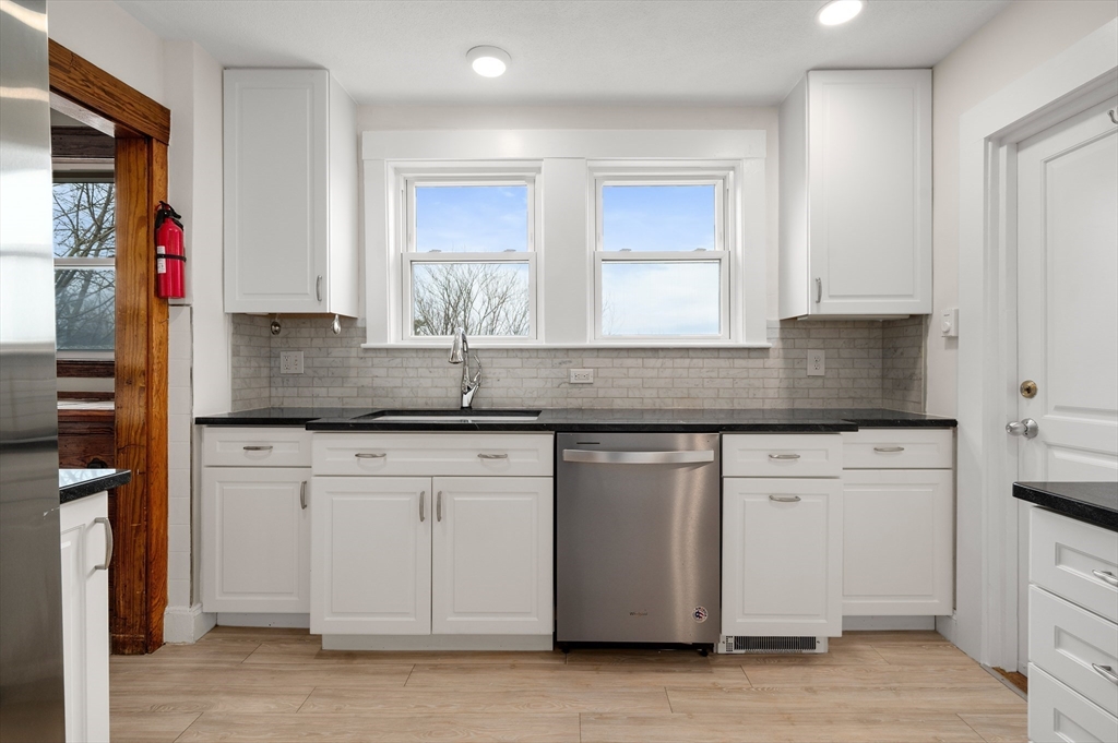 27 Union Street, Unit 3 Boston, MA 02135 - Photo 3 of 28 a kitchen with stainless steel appliances granite countertop a sink stove and cabinets