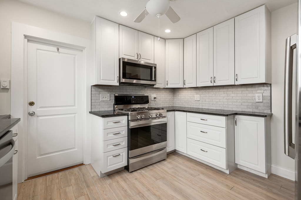 27 Union Street, Unit 3 Boston, MA 02135 - Photo 4 of 28 a kitchen with white cabinets stainless steel appliances and sink