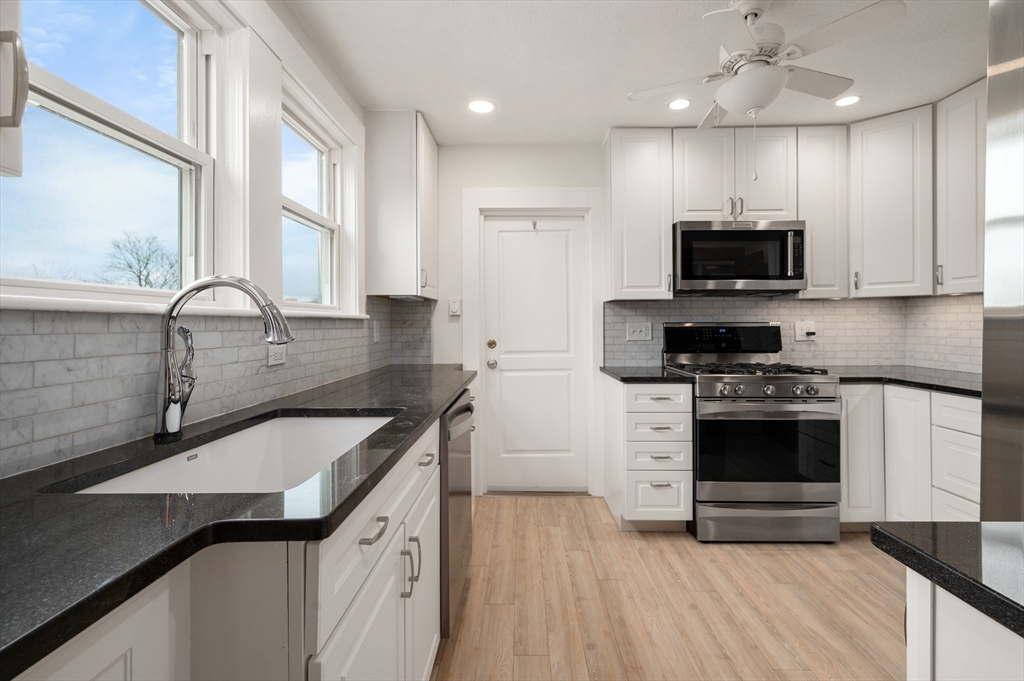 27 Union Street, Unit 3 Boston, MA 02135 - Photo 5 of 28 a kitchen with a sink stove and microwave
