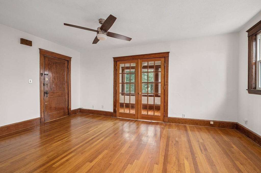 27 Union Street, Unit 3 Boston, MA 02135 - Photo 8 of 28 a view of an empty room with wooden floor and a window