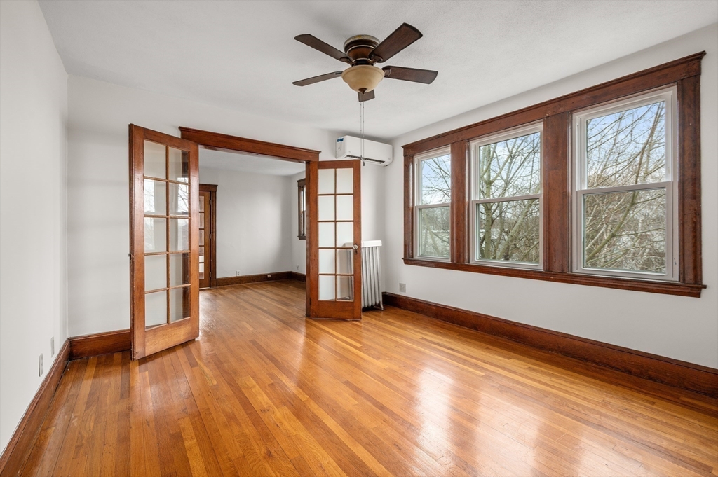 27 Union Street, Unit 3 Boston, MA 02135 - Photo 9 of 28 a view of an empty room with a window and wooden floor