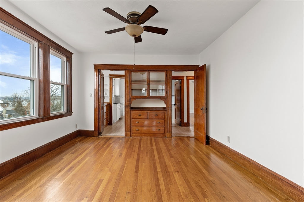 27 Union Street, Unit 3 Boston, MA 02135 - Photo 10 of 28 an empty room with wooden floor and windows