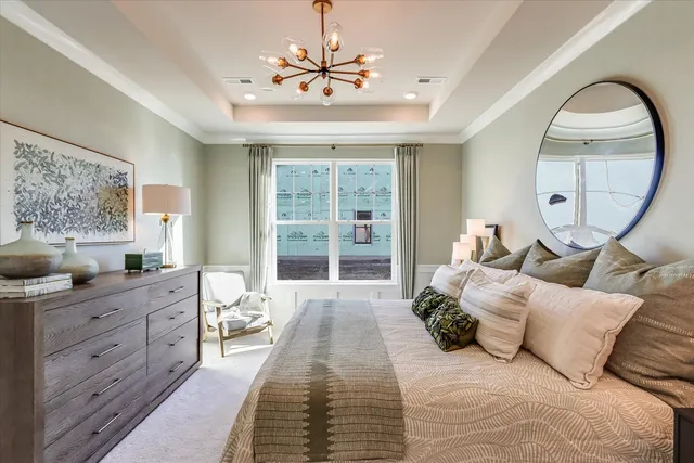 a spacious bedroom with a large bed and a large window