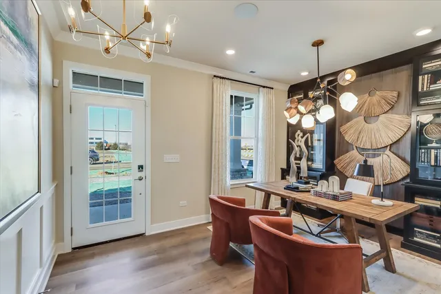 a living room with furniture a chandelier and a window
