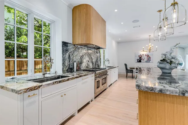 a kitchen with stainless steel appliances granite countertop a sink and a counter space