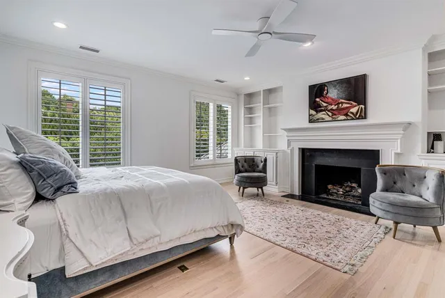 a bedroom with a bed a couch and a fireplace