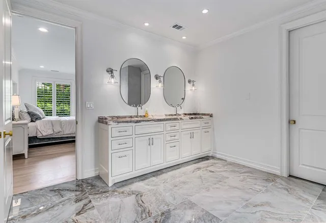 a spacious bathroom with a granite countertop sink a mirror and shower