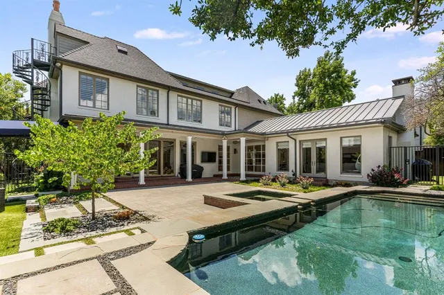 a front view of a building with swimming pool having outdoor seating