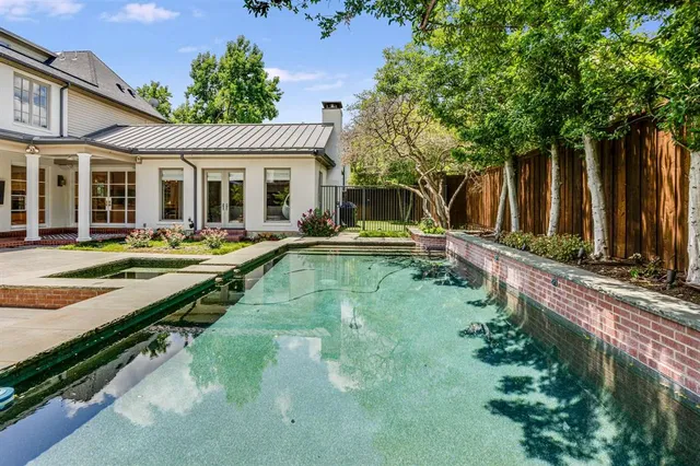 a view of a house with swimming pool and sitting area