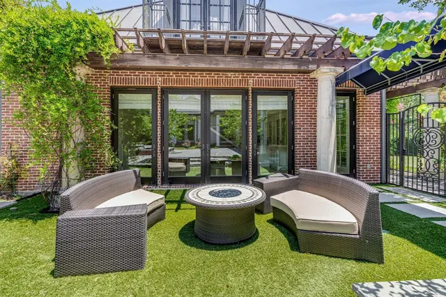 a view of a patio with couches chairs and a yard