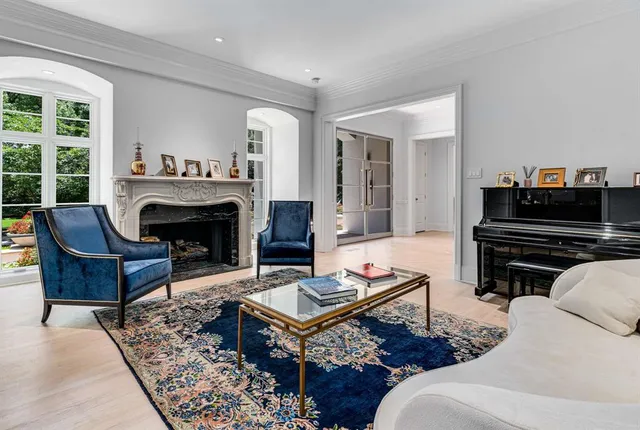 a living room with furniture a fireplace and a piano