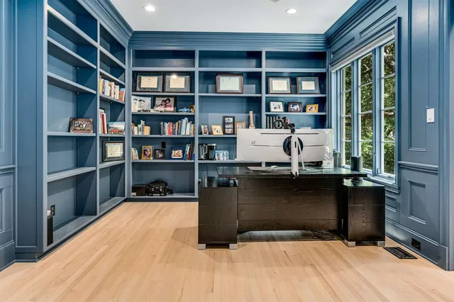 a living room with a bookshelf and a large window