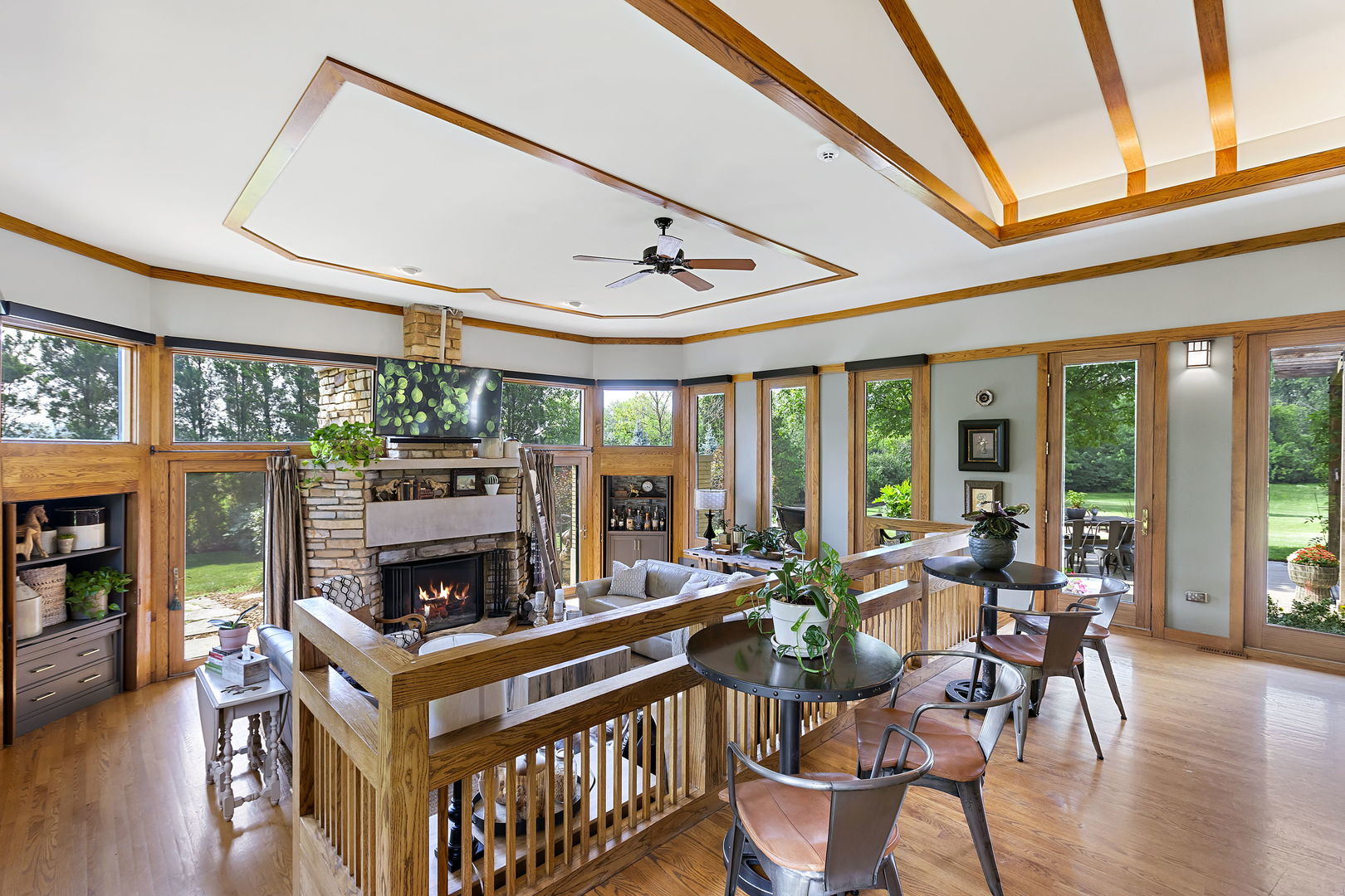13540 McCarthy Road Lemont, IL 60439 - Photo 10 of 71 a living room with furniture a fireplace and a floor to ceiling window