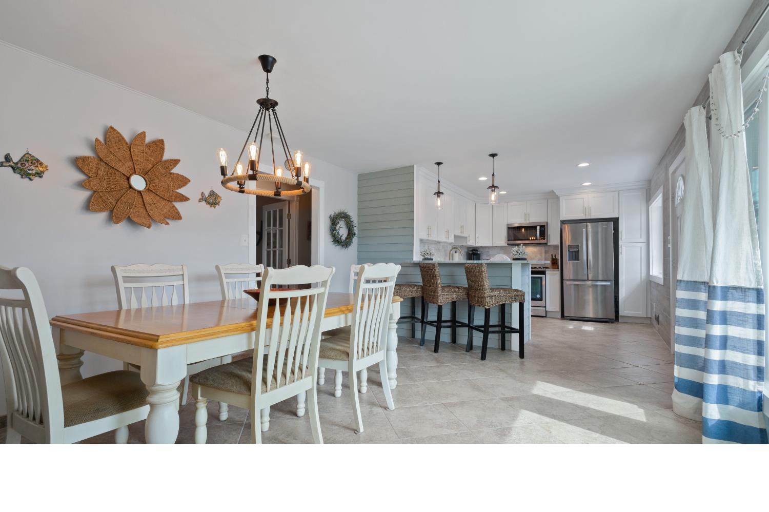 a living room filled with furniture and a chandelier