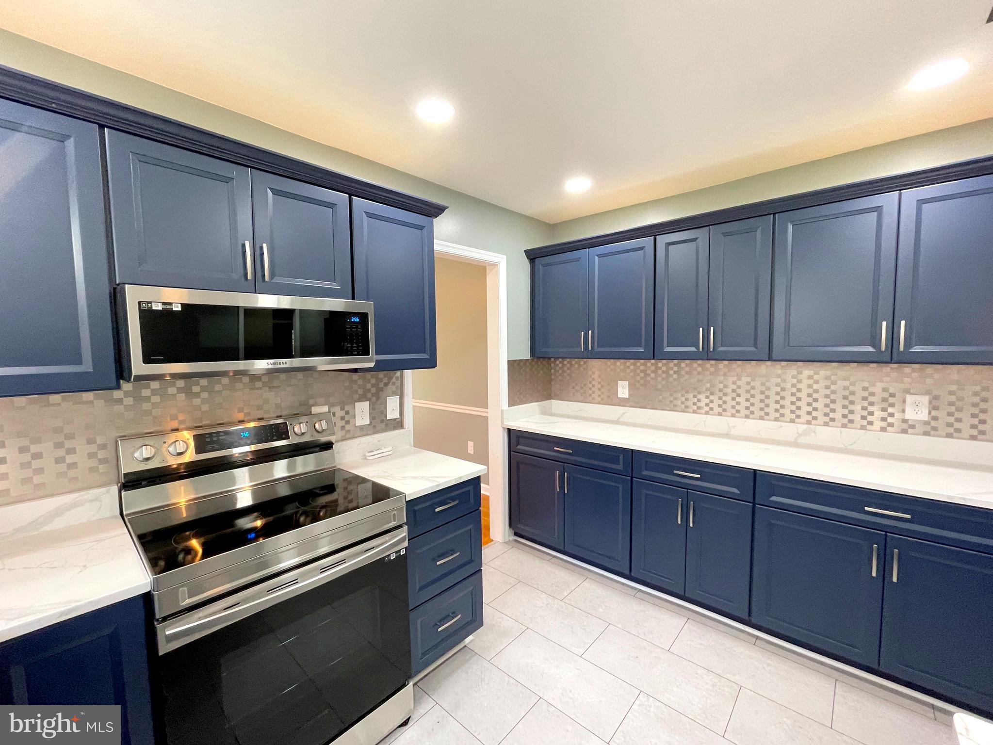 9457 Boyds Turn Road Owings, MD 20736 - Photo 14 of 46 a kitchen with wooden cabinets and stainless steel appliances