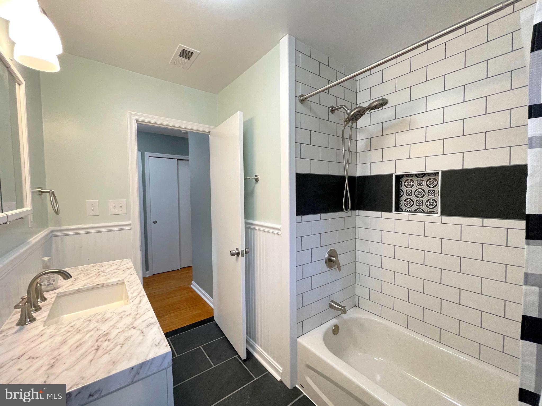 9457 Boyds Turn Road Owings, MD 20736 - Photo 21 of 46 a bathroom with a bathtub and a shower