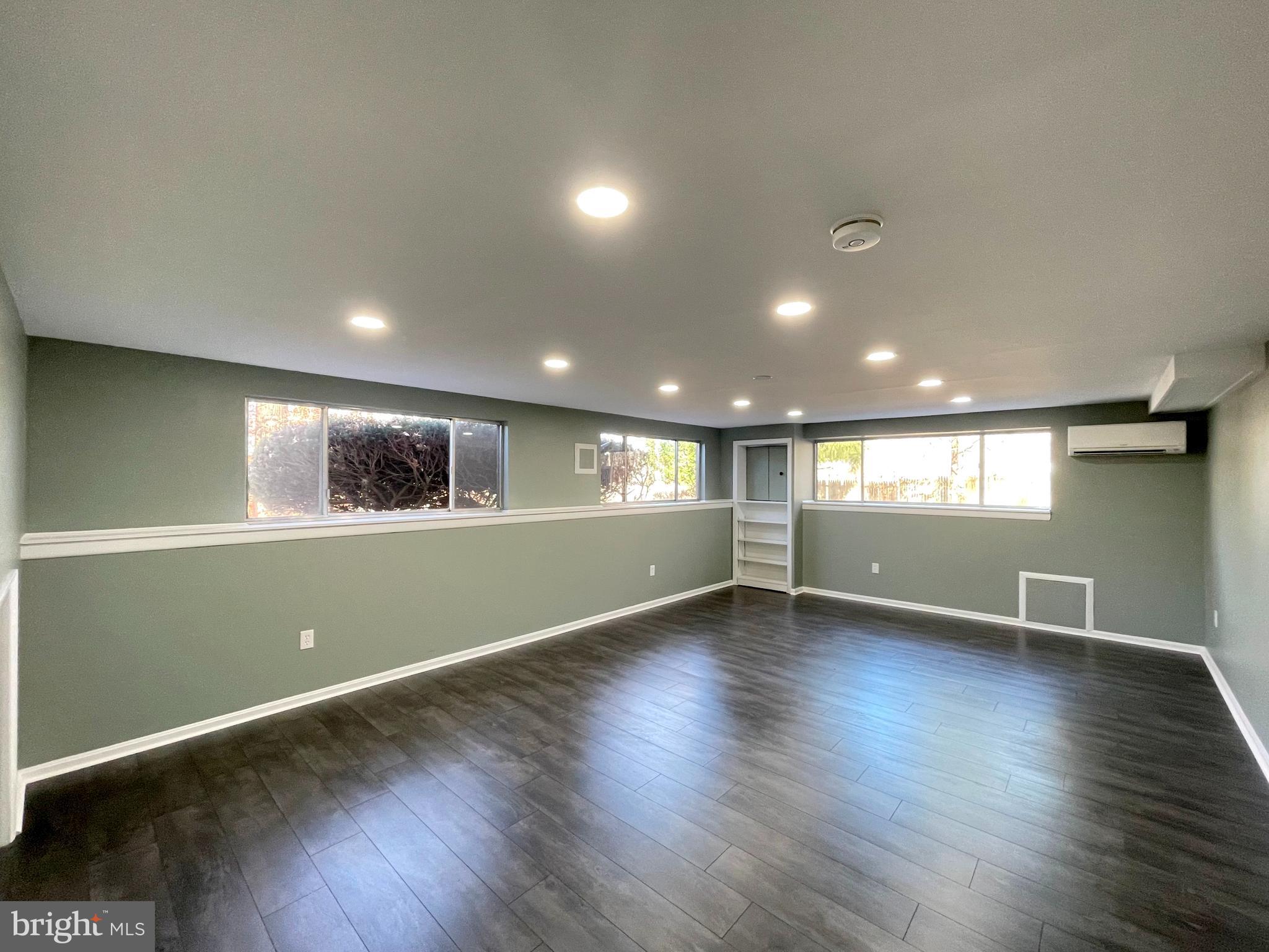 9457 Boyds Turn Road Owings, MD 20736 - Photo 27 of 46 an empty room with wooden floor and windows
