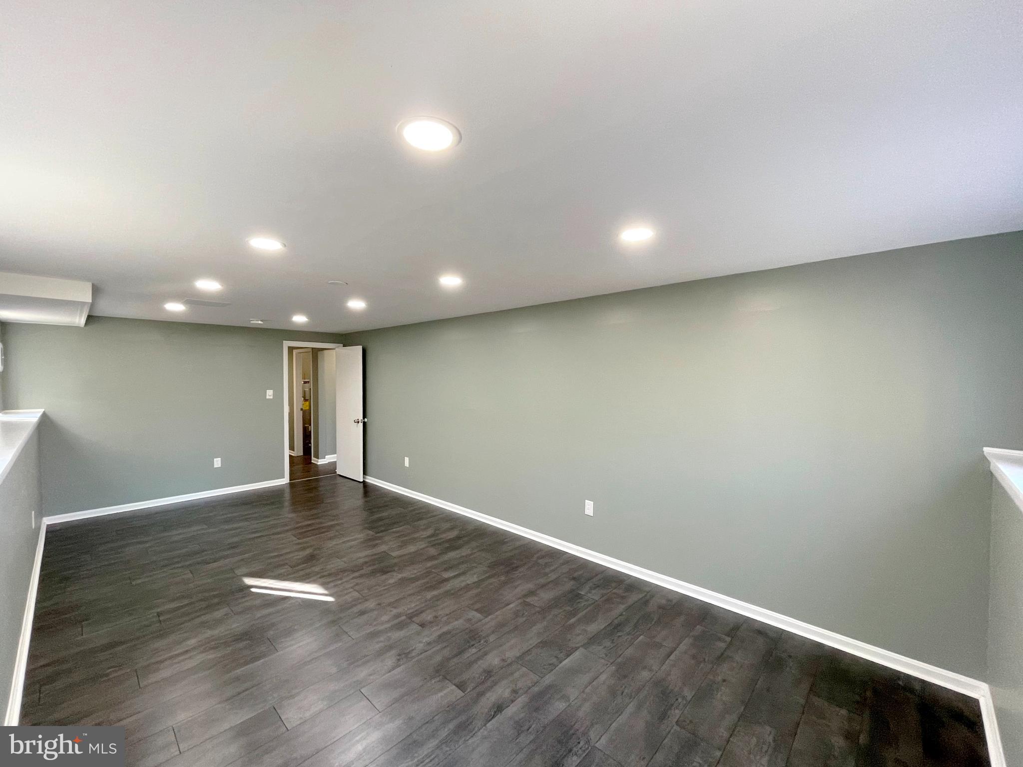 9457 Boyds Turn Road Owings, MD 20736 - Photo 30 of 46 an empty room with wooden floor and windows