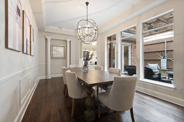 a view of a dining room with furniture wooden floor and chandelier