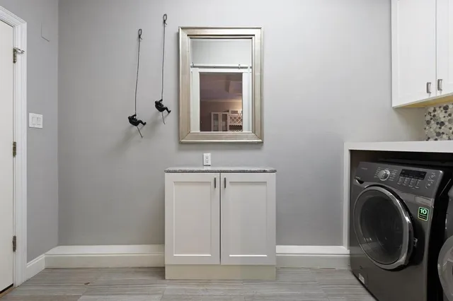 a view of a storage and utility room with washer and dryer