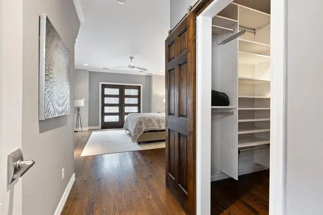 a view of a bedroom with wooden floor and windows