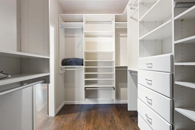 a view of walk in closet with empty racks