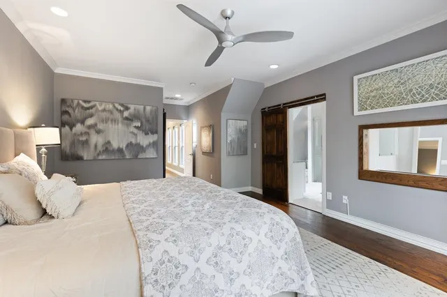 a bedroom with a large bed and a large mirror