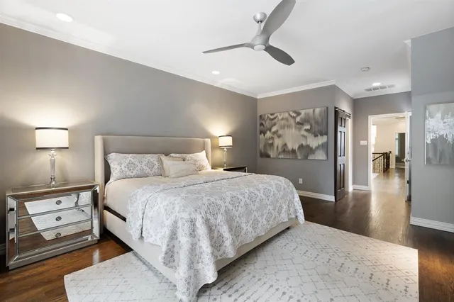 a bedroom with a bed and large mirror with window