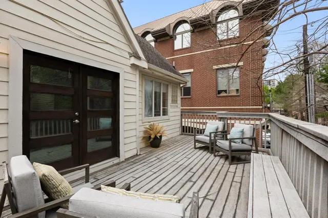 a balcony with wooden floor and furniture
