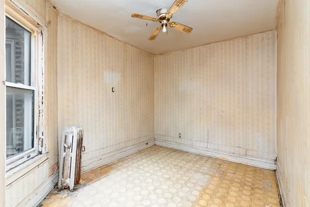 a view of room with window and ceiling fan
