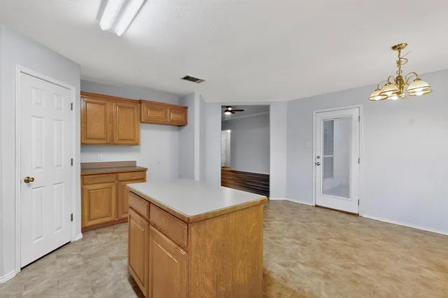 a kitchen with a stove and a refrigerator