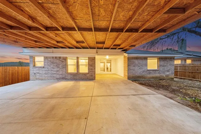 a view of a room with wooden floor and windows