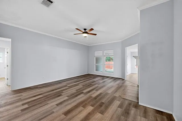 wooden floor in an empty room with a window