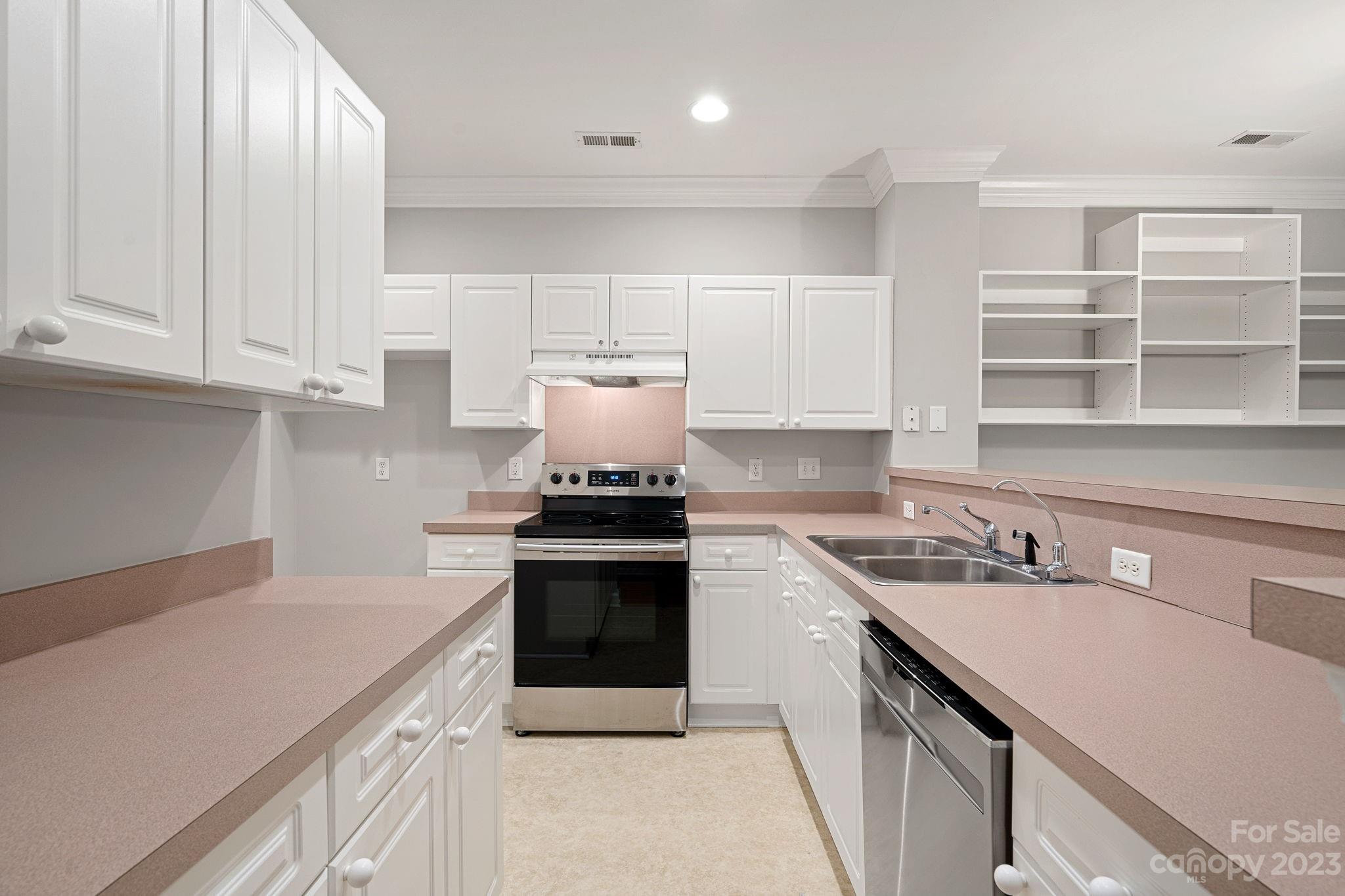 747 Peninsula Drive Davidson, NC 28036 - Photo 12 of 31 a kitchen with a sink stove and cabinets