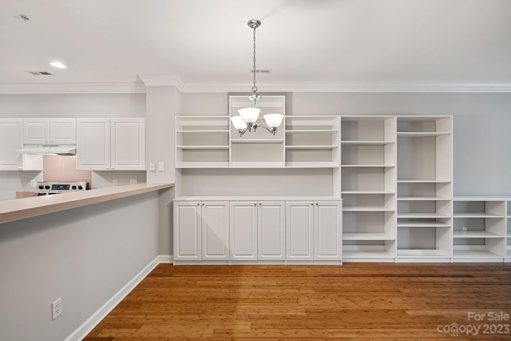 747 Peninsula Drive Davidson, NC 28036 - Photo 17 of 31 a view of a kitchen with a sink wooden cabinets and a window