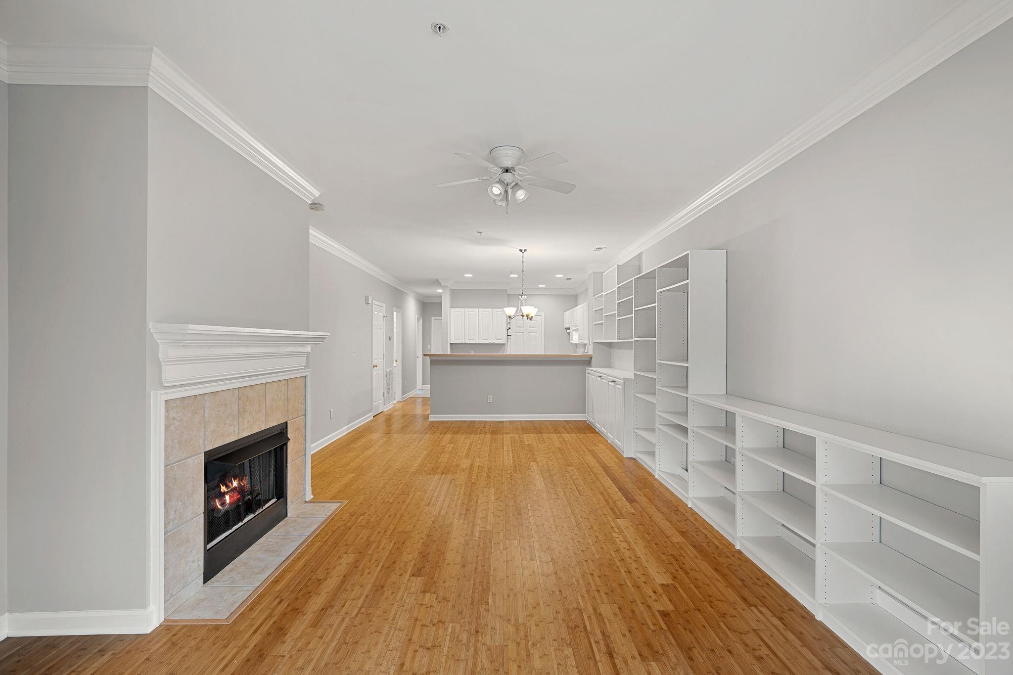 747 Peninsula Drive Davidson, NC 28036 - Photo 20 of 31 a view of a room with wooden floor a fireplace and windows